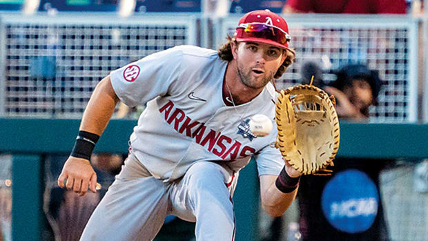 Razorbacks Peyton Stovall taking a throw at first base